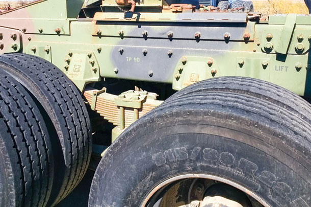 The upper frame rail of a military surplus truck must be lowered