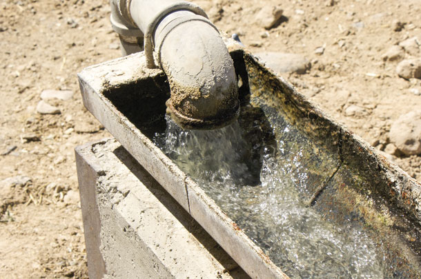 Water is carried by gravity from a water shed through an underground pipeline into the water trough