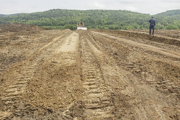 Construction of a new six-row, sand bedded freestall transition cow barn 